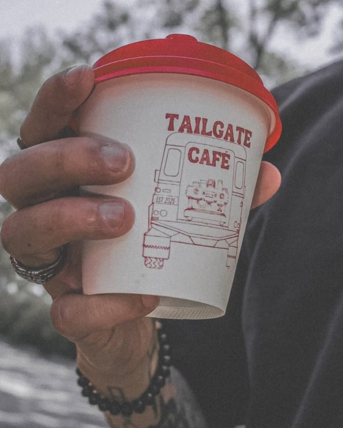 A Tailgate Café cup held in hand