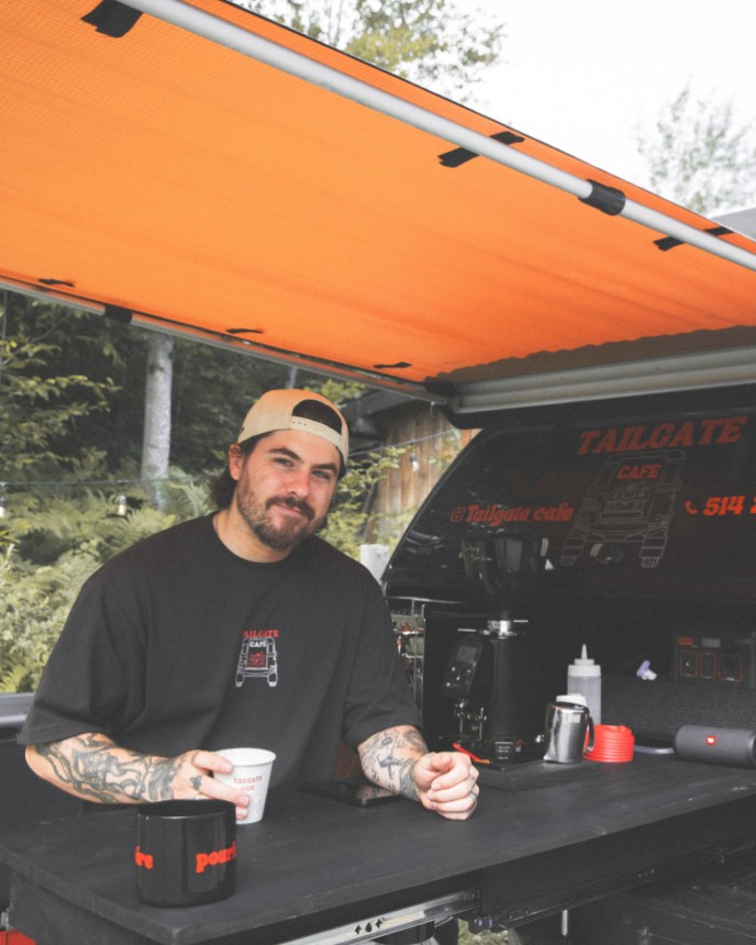 Barista at the Tailgate Café espresso bar, under the truck’s orange awning